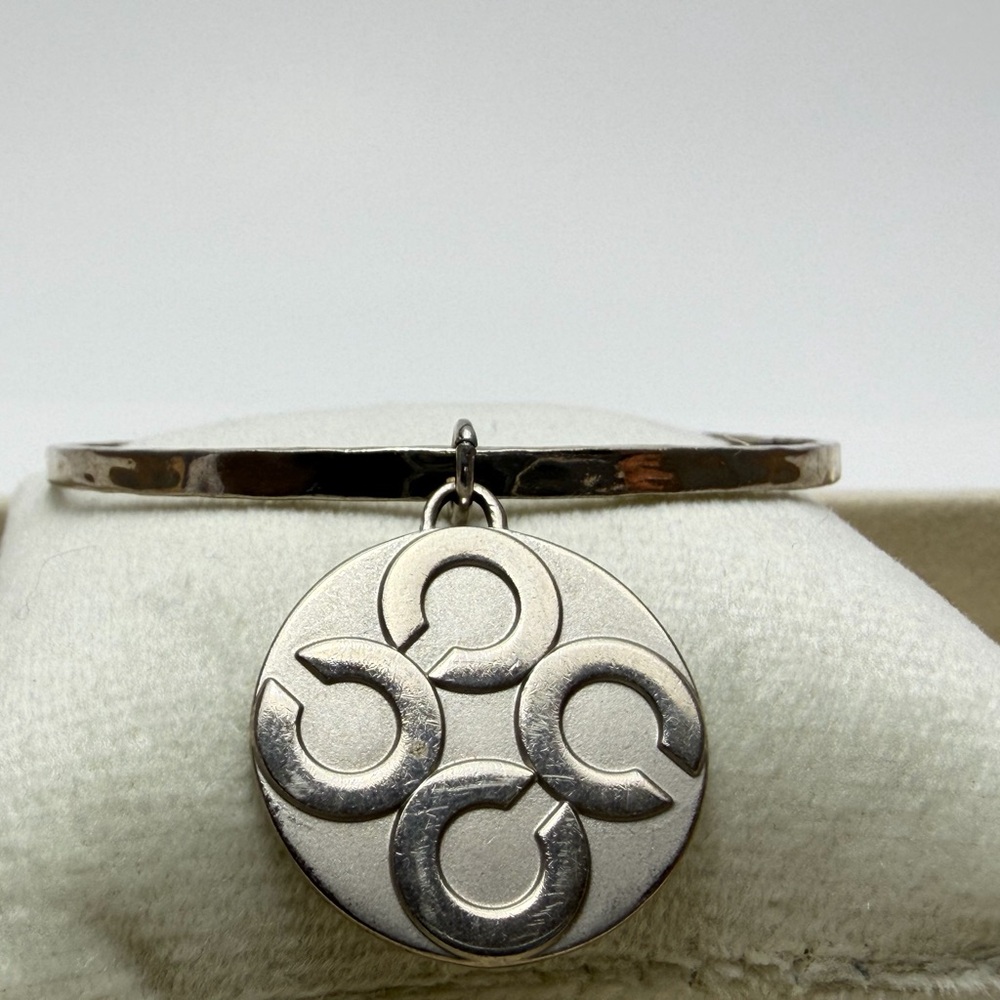 Chic COACH Silver Bangle with Circular Pendant